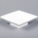 A 12 oz. bright white square porcelain bowl with a square base.