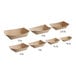 A row of brown Bagcraft Packaging EcoCraft paper food trays with curved edges.