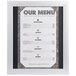 A white menu with black text in a white Aarco snap frame.