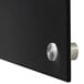A black rectangular Aarco glass markerboard surface with silver knobs.