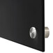 A black rectangular Aarco glass markerboard with silver knobs.