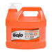 A plastic jug of GOJO Natural Orange liquid hand soap.