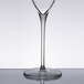 A Reserve by Libbey Rivere flute glass filled with wine on a reflective surface.