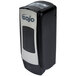 A close-up of a black and silver GOJO ADX-7 soap dispenser.