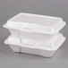 A stack of two white Genpak foam hinged lid containers.
