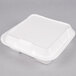 A white square Genpak foam container with a hinged lid.
