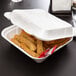 A white Genpak styrofoam container with food in it.