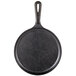 A black Lodge cast iron griddle with a handle.