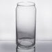 A Libbey can glass filled with a clear liquid on a white background.