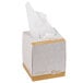 A white tissue box with a brown tissue inside.