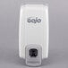 A white GOJO soap dispenser with grey accents and text.