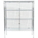 A white metal wire security cage with shelves inside.