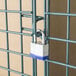 A green metal security cage door with a lock.