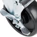 A black wheel swivel stem caster with a metal handle.