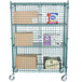 A metal Regency security cage filled with boxes on a metal cart.