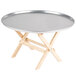 A Tablecraft mini table tray stand with a natural finish on a round table.