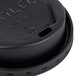 A close-up of a Solo black hot cup lid on a cup.