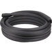 A black coiled rubber hose for a Manitowoc ice machine on a white background.
