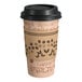 A Choice paper coffee cup with a black lid and sleeve.