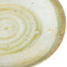 A close up of a white Carlisle round melamine bread and butter plate with a brown swirl pattern.