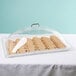 A Cambro clear dome cover on a tray of cookies.