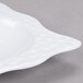 A close-up of a white Las Brisas melamine bowl with a pattern on it.