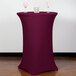 A burgundy Snap Drape Contour Cover on a round bar height table.