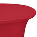 A Snap Drape crimson spandex table cover with a round top on a bar table.