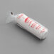 A white roll of paper with a red text label for white fluted mini baking cups.