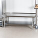 A stainless steel Advance Tabco equipment stand with undershelf.