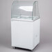 A white freezer with a curved glass top.