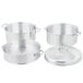 Three silver Vollrath aluminum pots with handles and lids.