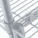 A close-up of a metal shelf with a pipe on a white background.