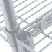 A close-up of a metal shelf with a Metro Super Erecta Brite wire shelf.