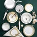 A table setting with white Visions plastic plates and silverware.
