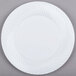 A white Visions plastic plate with a circular pattern.