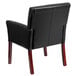 A Flash Furniture black leather reception chair with mahogany legs.