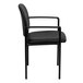 A Flash Furniture black vinyl side chair with arms.