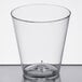 A Choice clear plastic shot glass on a white surface.