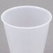 A close up of a Dart translucent plastic cup on a gray surface.