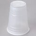 A Dart translucent white plastic cup on a gray surface.
