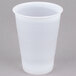 A Dart translucent plastic cup on a gray surface.