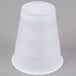 A Dart Y7 Conex white plastic cup on a gray surface.