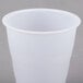 A Dart Y7 translucent plastic cup on a gray surface.