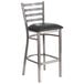 A clear-coated metal restaurant barstool with a black vinyl seat.