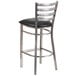 A Clear-Coated Ladder Back metal restaurant barstool with a black vinyl seat.