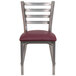 A Flash Furniture metal restaurant chair with a burgundy vinyl seat and ladder back.