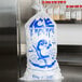 A Choice plastic bag of ice with an ice print label on a counter.