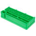 A green plastic block with compartments and holes.