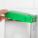 A hand holding a green Edlund HACCP colored insert.